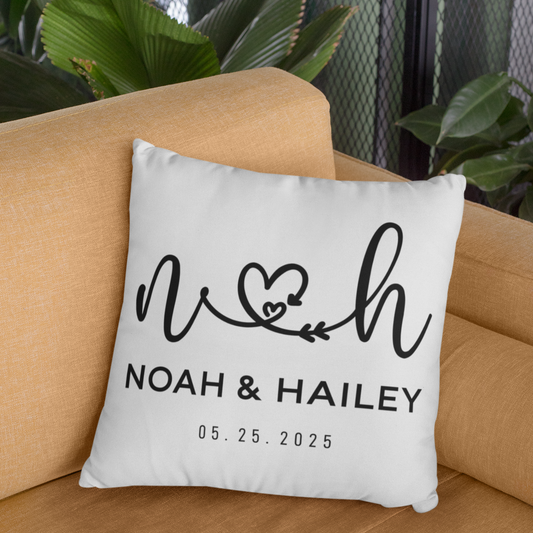 Decorative pillow with 'Noah & Hailey' text on a beige couch
