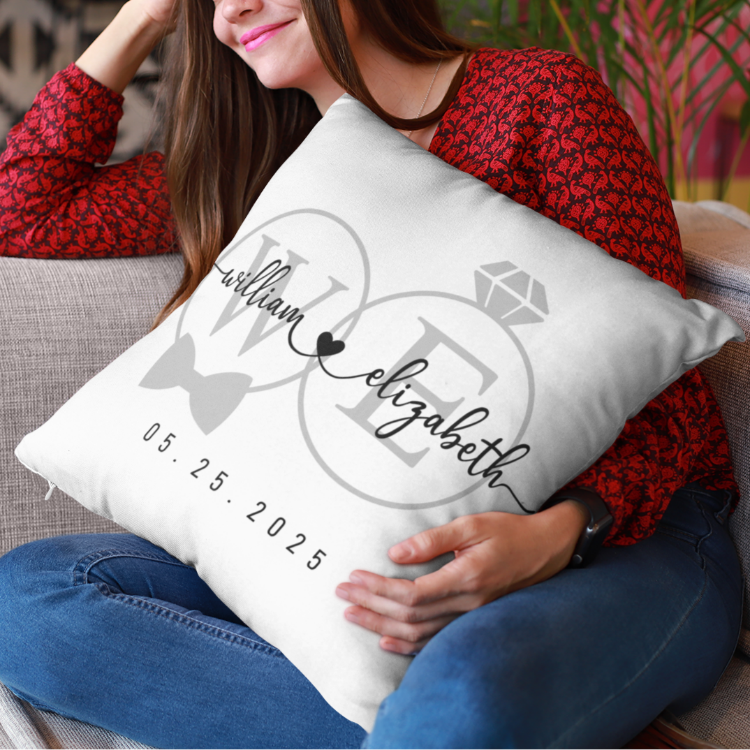 Woman holding a personalized pillow with names and date on a couch