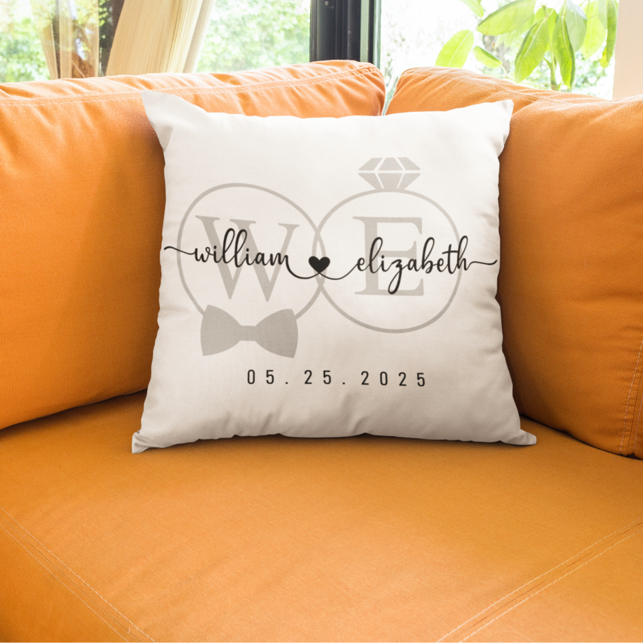 White pillow with personalized design on an orange couch