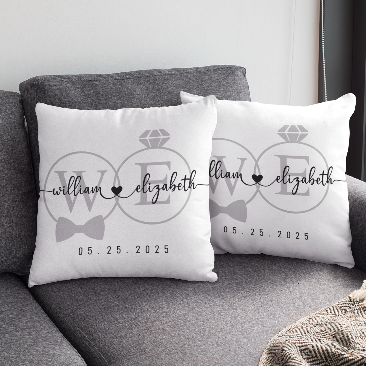 Two decorative pillows with personalized text on a gray couch.