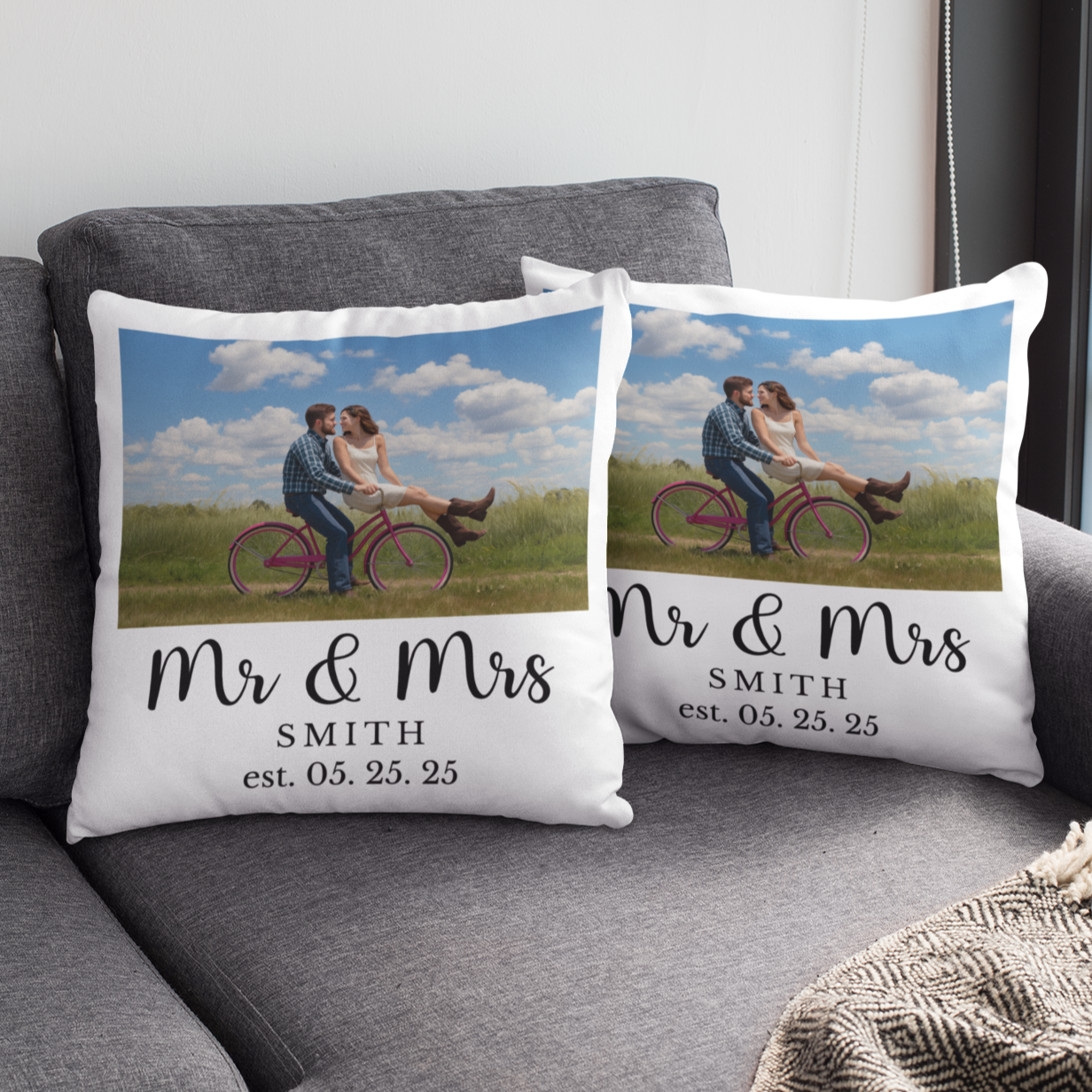 Personalized 'Mr & Mrs' pillows on a gray couch with a cup of coffee on a small table.