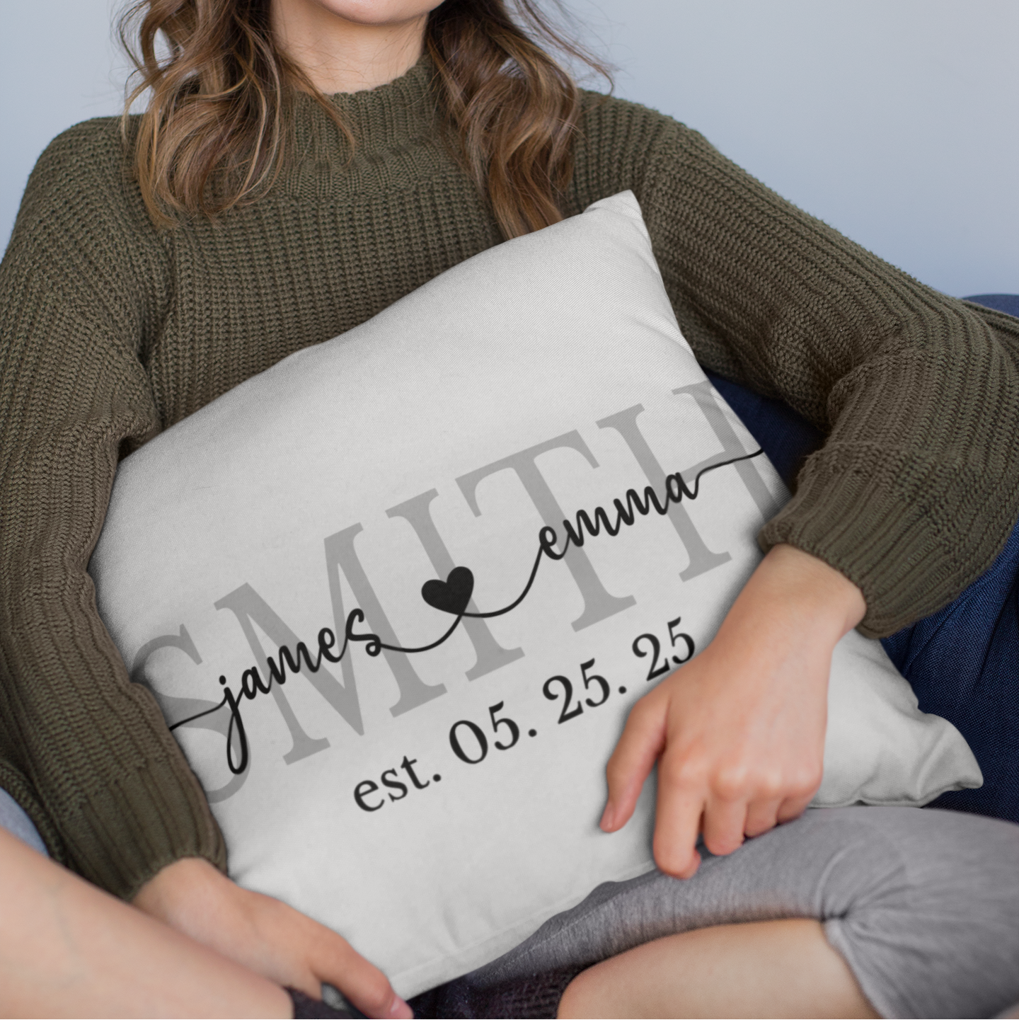 Woman holding a pillow with personalized text